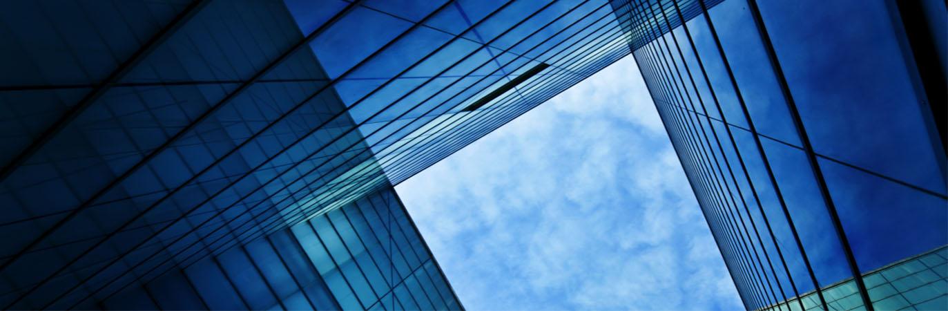 Looking up at glass facades of buildings